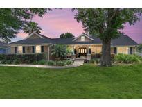 Charming ranch-style home boasting manicured lawn, mature trees, and a welcoming entrance at 5437 Se 34Th St, Ocala, FL 34480