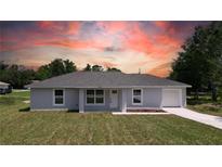 Charming single-story home with a well-maintained lawn and neutral paint, illuminated by a vibrant sunset backdrop at 5635 Nw 2Nd St, Ocala, FL 34482