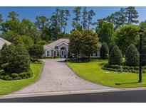 Charming single-story home with a well-manicured lawn and a long, elegant driveway at 8033 Nw 29Th Street Rd, Ocala, FL 34482