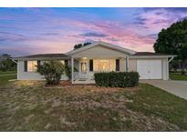 Charming single-story home with a manicured front yard and attached garage, perfect for suburban living at 8375 Sw 109Th Lane Rd, Ocala, FL 34481