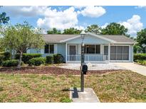 Charming single-story home with a well-maintained yard and covered front porch at 8463 Sw 108Th Pl, Ocala, FL 34481