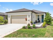Charming single-story home featuring a well-manicured lawn and two-car garage at 8820 Sw 58Th Street Rd, Ocala, FL 34481