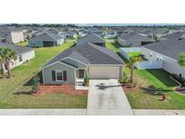 Charming single-story home featuring a two-car garage and well-manicured landscaping at 9266 Sw 58Th Cir, Ocala, FL 34476