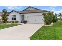 Charming single-story home with a well-manicured lawn and a two-car garage at 9459 Sw 52Nd Loop, Ocala, FL 34481