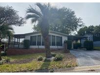 Charming single-story home with a well-maintained lawn and mature landscaping at 1408 Torrey Pines Dr, Lady Lake, FL 32159