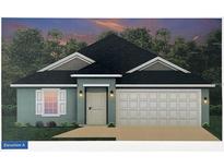 Charming one-story home with a two-car garage, complemented by a neatly landscaped front yard and classic design at 15106 Se 94Th Ter, Summerfield, FL 34491