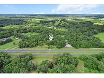 Expansive aerial view of a wooded property showcasing its privacy and natural surroundings at 16120 Nw Us Highway 27, Williston, FL 32696