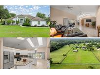 Charming single-story home with a pristine lawn, mature landscaping, and a welcoming entrance at 5661 Nw 96Th Ln, Ocala, FL 34482