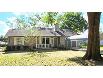 Charming single-story home with a well-maintained lawn, covered carport and gray siding at 70 Almond Pass Dr, Ocala, FL 34472