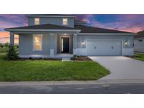 Charming two-story home featuring a well-manicured lawn and a two-car garage with stylish curb appeal at 7536 Sw 60Th St, Ocala, FL 34476