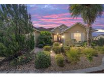 Charming home featuring lush landscaping, beautiful bushes, and a well-manicured lawn at sunset at 8650 Sw 83Rd Loop, Ocala, FL 34481