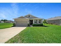 Charming single-story home featuring a well-manicured lawn and attached two-car garage at 8870 Sw 62Nd Ave, Ocala, FL 34476
