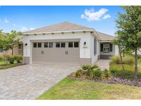 Charming single-story home featuring a two-car garage, well-maintained landscaping, and a welcoming entrance at 10427 Sw 98Th Place Rd, Ocala, FL 34481