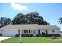 Charming single-story home boasts a well-manicured lawn and welcoming front porch at 13762 Sw 112Th Ter, Dunnellon, FL 34432