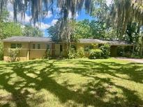 A single-story home featuring classic architecture and a spacious front yard at 1819 Se 4Th Ave, Ocala, FL 34471
