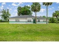 Charming single-story home with lush green lawn and well-maintained landscaping, offering curb appeal at 2521 Nw 45Th Pl, Ocala, FL 34475