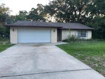 Charming single-story home with a two-car garage and concrete driveway at 4840 Ne 23Rd Ave, Ocala, FL 34479