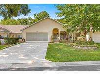 Charming one-story home with well-manicured lawn, beautiful landscaping, and attached two-car garage at 8710 Sw 91St St # E, Ocala, FL 34481