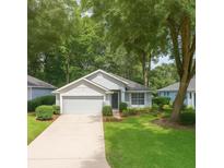 Charming single-story home featuring a manicured lawn and an attached two-car garage at 8926 Sw 192Nd Court Rd, Dunnellon, FL 34432