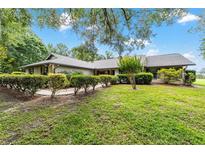 Charming single-story home with well-manicured lawn and mature landscaping, creating a welcoming curb appeal at 8940 Sw 8Th St, Ocala, FL 34481