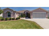 Charming single-story home featuring manicured landscaping and a two-car garage at 1377 Sw 161St Pl, Ocala, FL 34473