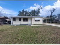 Charming single-story home featuring a covered carport and front yard at 2215 Ne 16Th Ct, Ocala, FL 34470