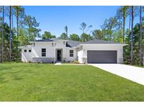 Charming one-story home with a well-manicured lawn and a two-car garage at 2254 Amberly Ave, Orlando, FL 32833