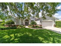Charming home with a well-manicured lawn and stone accents beneath the windows at 2417 Se 23Rd St, Ocala, FL 34471