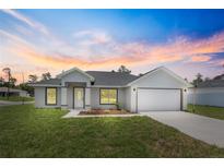Charming one-story home with a well-manicured lawn and attached two-car garage at 3079 Sw 168 Pl, Ocala, FL 34473