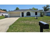 Charming single-story home with a well-maintained lawn and an attached one car garage at 6 Bahia Trace Loop, Ocala, FL 34472