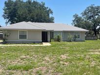 Well-maintained single story home featuring a new metal roof and manicured front yard at 6051 Ne 25Th Ave, Ocala, FL 34479
