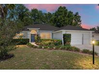 Charming single-story home featuring well-maintained landscaping, a two-car garage, and a welcoming front entrance at 8053 Sw 62Nd Ave, Ocala, FL 34476