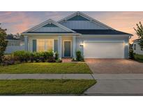Charming single-story home with a well-manicured lawn and a brick driveway leading to an attached two-car garage at 1875 Nw 44 Ct, Ocala, FL 34482