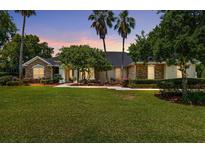 Charming single-story home featuring a lush front yard and beautiful stone accents at 2010 Se 25Th St, Ocala, FL 34471