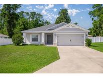 Charming single-story home with a well-manicured lawn and a two-car garage, perfect for suburban living at 4909 Se 89Th St, Ocala, FL 34480
