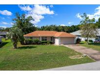 Charming single story home with a well manicured lawn and an attached two car garage at 4992 Nw 31St St, Ocala, FL 34482