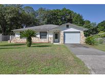Charming single-Gathering home with stone accents, fresh lawn, and a one-car garage at 5060 Ne 4Th St, Ocala, FL 34470