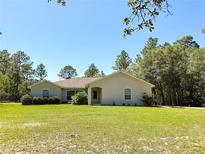 Charming single-story home with a well-manicured lawn, beautiful landscaping, and a classic roofline at 7134 Sw 129Th Terrace Road, Ocala, FL 34481