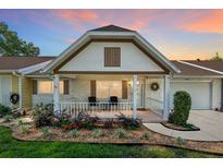 Charming home featuring a cozy front porch, well-kept landscaping, and inviting curb appeal at dusk at 8524 Sw 90Th Ln # B, Ocala, FL 34481