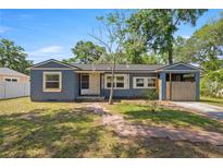 Charming single-story home with blue siding and a brick walkway, inviting curb appeal at 1014 Ne 12Th St, Ocala, FL 34470