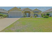 Charming single-story home with a well-maintained lawn and inviting curb appeal at 14004 Se 94Th Ave, Summerfield, FL 34491