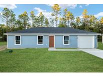 Single-story home with a front yard and attached garage at 315 Sw 140 Ave, Ocala, FL 34481