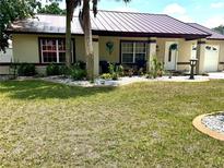 Well maintained single story home with green grass, palm trees and white rock landscaping at 340 Oak Track Loop, Ocala, FL 34472