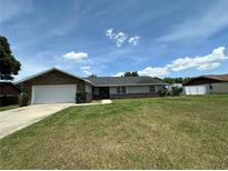 Charming single-story home with a well-maintained lawn and attached two-car garage at 5525 Se 43Rd Ct, Ocala, FL 34480