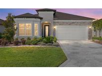 Charming single-story home boasts stone accents, a well-manicured lawn, and a two-car garage with beautiful pavers at 5728 Sw 90Th Court Rd, Ocala, FL 34481