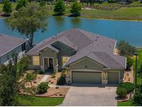 Inviting one-story home with a three car garage and lovely lake view at 9511 Sw 71St Loop, Ocala, FL 34481