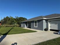 Charming single-story home with a well-maintained lawn and long concrete driveway at 1100 Nw 126Th Ln, Citra, FL 32113