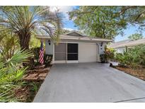 Welcoming facade with a two-car garage and beautiful landscaping at 9001 Sw 91St Cir, Ocala, FL 34481