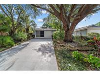 Charming single-story home with lush landscaping and an inviting driveway at 9001 Sw 91St Cir, Ocala, FL 34481