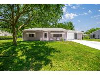 Inviting single-story home with a well-manicured lawn and covered entry for curb appeal at 9021 Sw 108Th Pl, Ocala, FL 34481